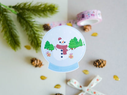Sticker matte Cute Snowglobe with a Snowman and gifts perfect to decorate every surface to celebrate the Holidays